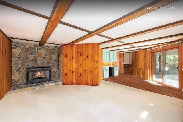 334 Back Nine Ln, Sapphire, NC 28774 - unfurnished living room with beamed ceiling, wooden walls, a fireplace, and carpet flooring