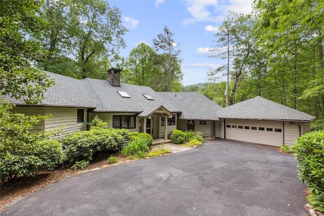 334 Back Nine Ln, Sapphire, NC 28774 - single story home featuring a chimney, a garage, driveway, and a shingled roof