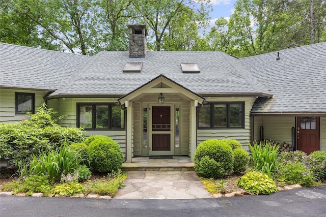 334 Back Nine Ln, Sapphire, NC 28774 - view of front of property with a shingled roof and a chimney