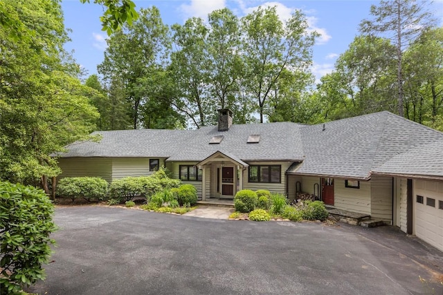 334 Back Nine Ln, Sapphire, NC 28774 - view of front of home featuring a chimney, roof with shingles, and asphalt driveway