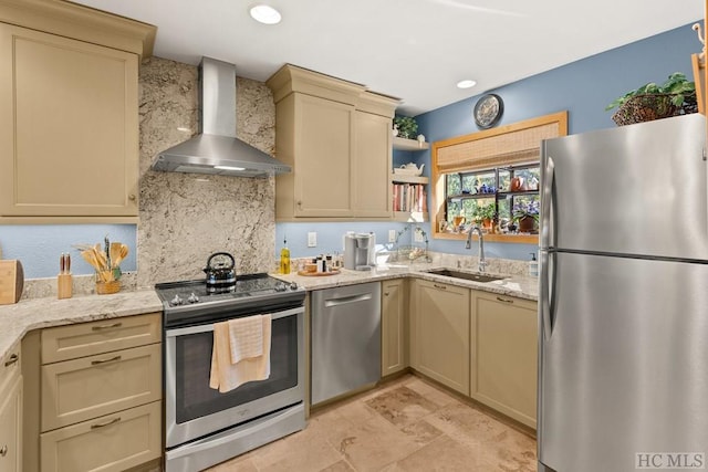 kitchen with wall chimney range hood, sink, backsplash, stainless steel appliances, and cream cabinetry