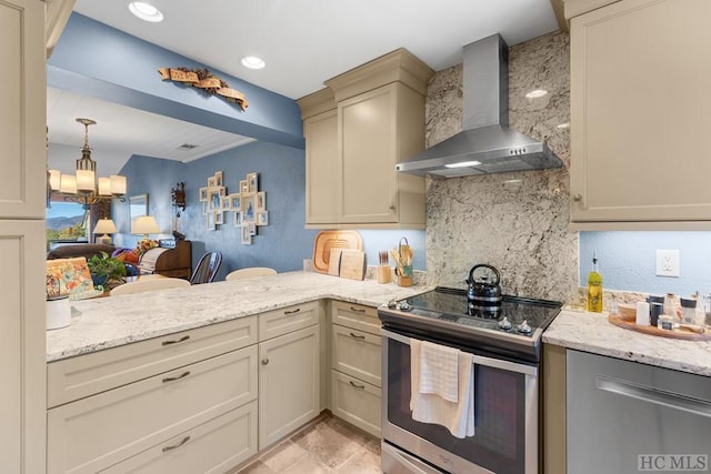 kitchen featuring tasteful backsplash, cream cabinets, wall chimney range hood, an inviting chandelier, and stainless steel electric range