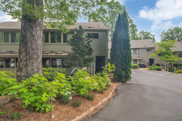 55 Toxaway Shrs Unit 14, Lake Toxaway, NC 28747 - view of front of house with uncovered parking and a shingled roof