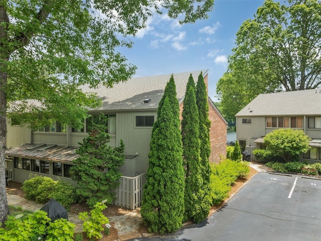 55 Toxaway Shrs Unit 14, Lake Toxaway, NC 28747 - view of side of home with roof with shingles and uncovered parking