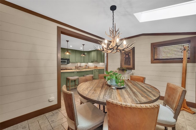 55 Toxaway Shrs Unit 14, Lake Toxaway, NC 28747 - dining space with a chandelier, a skylight, wood walls, and vaulted ceiling