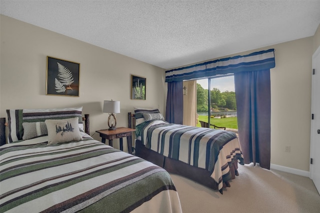 55 Toxaway Shrs Unit 14, Lake Toxaway, NC 28747 - carpeted bedroom featuring a textured ceiling and access to exterior
