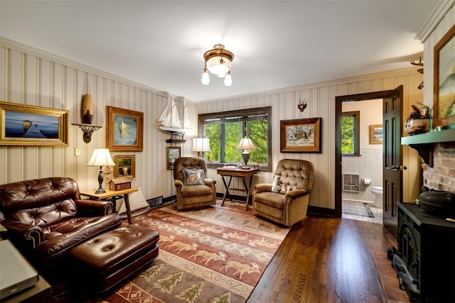515 Stillmont Cir, Cashiers, NC 28717 - living room featuring a wood stove, wood finished floors, and ornamental molding
