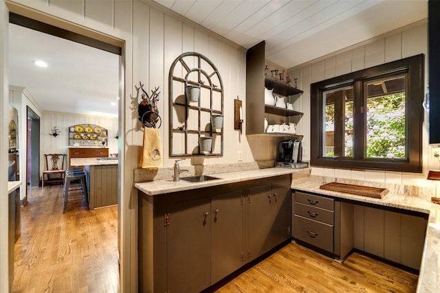 515 Stillmont Cir, Cashiers, NC 28717 - kitchen with a sink, ornamental molding, light wood finished floors, light stone counters, and wood walls
