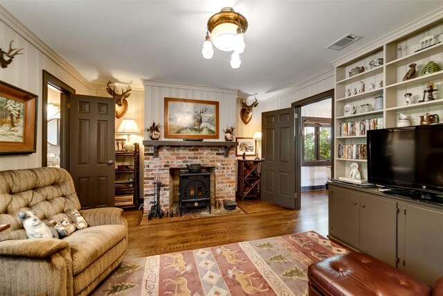 515 Stillmont Cir, Cashiers, NC 28717 - living room featuring ornamental molding, a wood stove, and wood finished floors