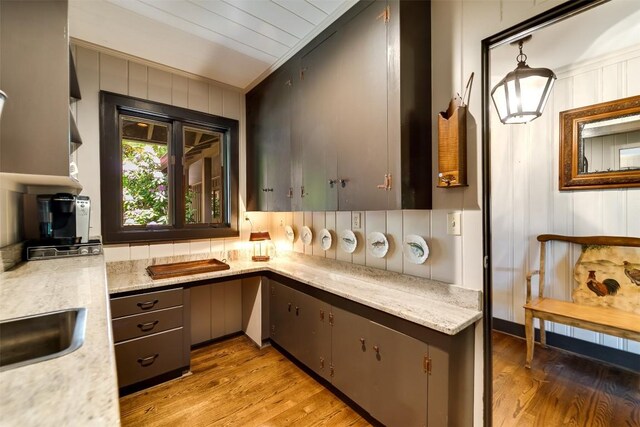 515 Stillmont Cir, Cashiers, NC 28717 - kitchen with light wood finished floors, crown molding, a sink, and wooden walls