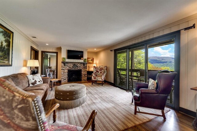 515 Stillmont Cir, Cashiers, NC 28717 - living room with crown molding, a brick fireplace, wood finished floors, and baseboards