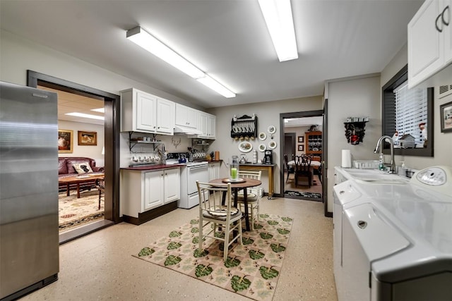 515 Stillmont Cir, Cashiers, NC 28717 - kitchen with white electric range oven, washer and clothes dryer, a sink, white cabinetry, and under cabinet range hood