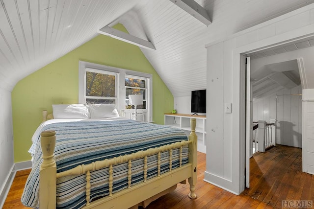 bedroom with hardwood / wood-style floors and vaulted ceiling