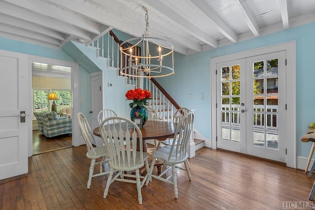 dining room featuring beamed ceiling, plenty of natural light, dark wood-type flooring, and french doors