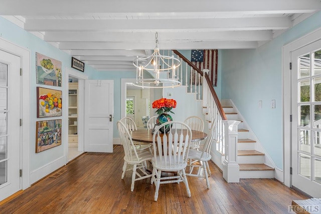 dining space with dark wood-type flooring, beam ceiling, and a chandelier