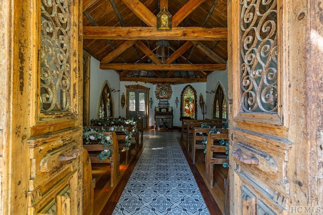 interior space featuring vaulted ceiling with beams and wood ceiling