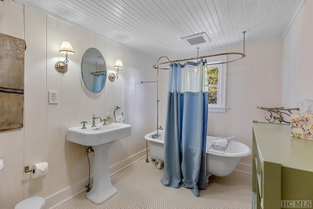 bathroom featuring tile patterned flooring and shower / bath combination with curtain