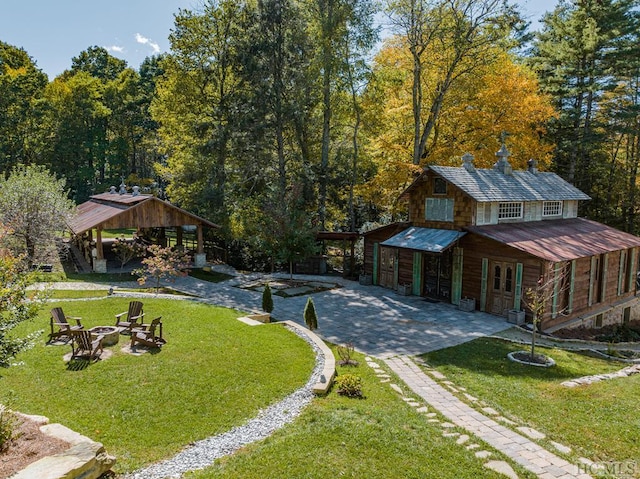 exterior space with a lawn and an outdoor fire pit