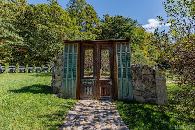 property entrance with a lawn