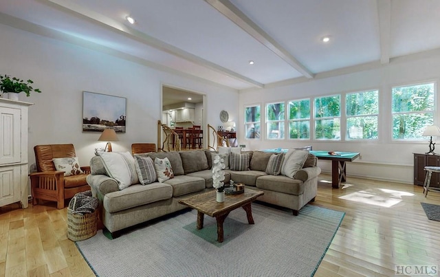 living room featuring beamed ceiling, pool table, and light wood-type flooring