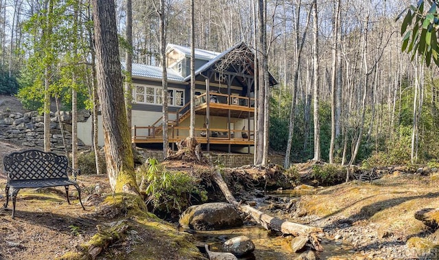 back of house with a wooden deck