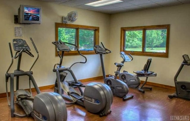 exercise room with a paneled ceiling