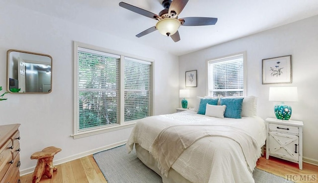 bedroom with light hardwood / wood-style floors and ceiling fan