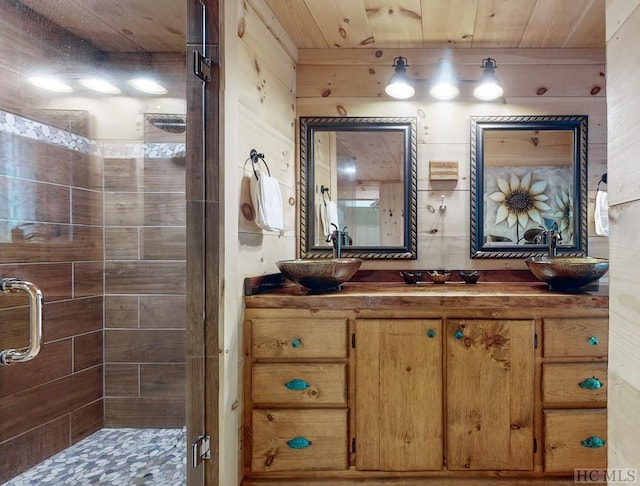 bathroom featuring a shower with door, vanity, wooden ceiling, and wooden walls