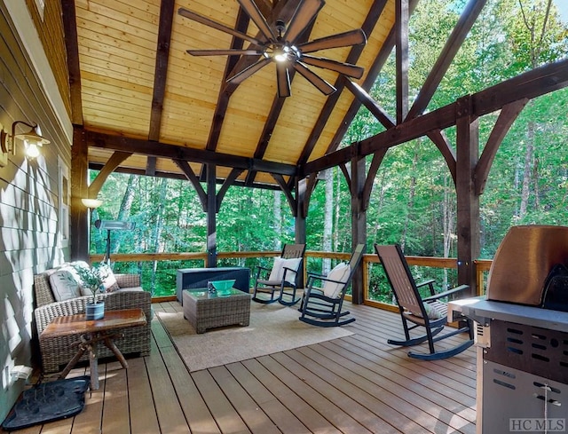 wooden terrace featuring an outdoor living space, a gazebo, and ceiling fan