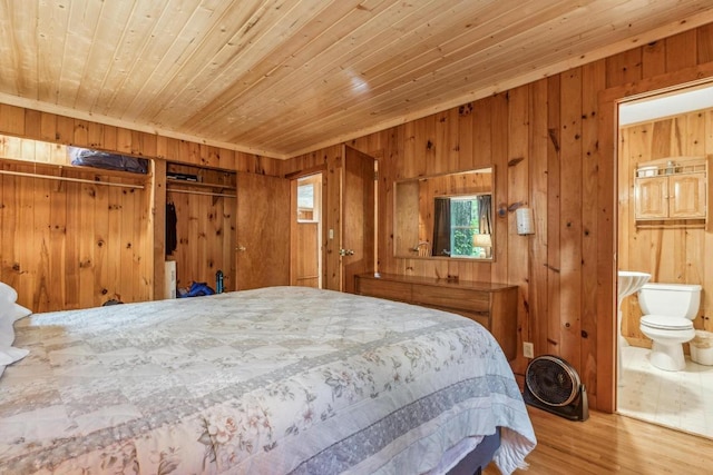bedroom featuring wooden ceiling, wooden walls, wood finished floors, and connected bathroom