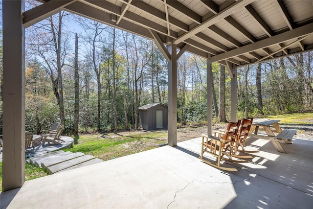 view of patio with a storage shed, outdoor dining area, and an outdoor structure