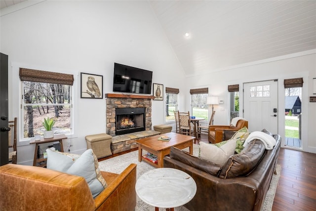 living area with a fireplace, recessed lighting, high vaulted ceiling, and hardwood / wood-style floors