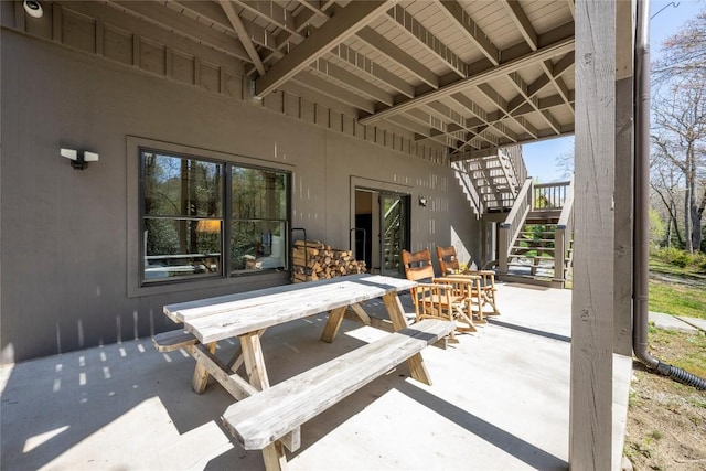 view of patio / terrace with outdoor dining area and stairs