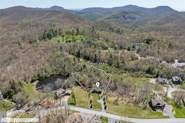 bird's eye view with a view of trees and a water and mountain view