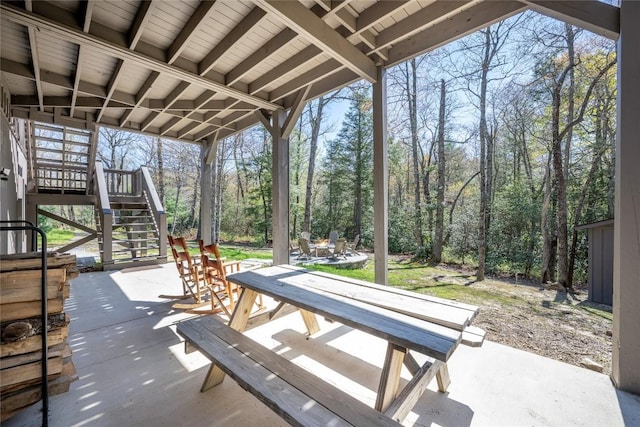view of patio featuring stairs and a fire pit