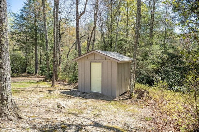 view of shed with a wooded view