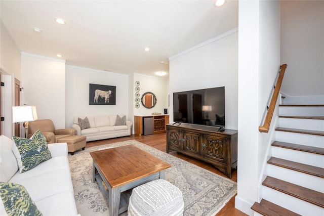 living room featuring stairs, recessed lighting, ornamental molding, and wood finished floors