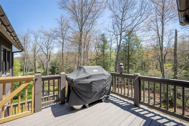 wooden terrace with a grill