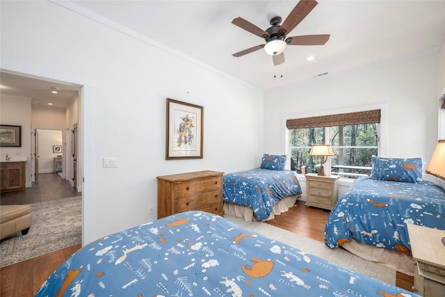 bedroom featuring ornamental molding, recessed lighting, wood finished floors, and visible vents