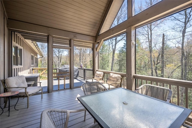 sunroom / solarium featuring outdoor dining space