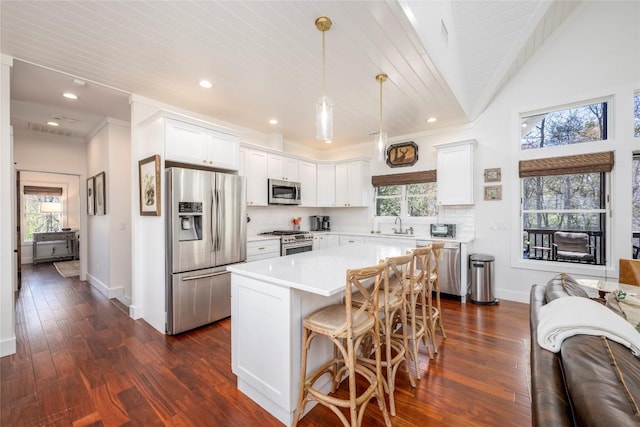 kitchen with light countertops, baseboards, stainless steel appliances, and recessed lighting
