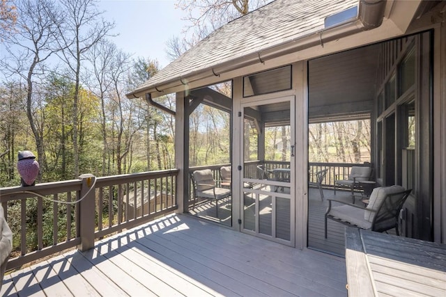 wooden deck featuring a sunroom