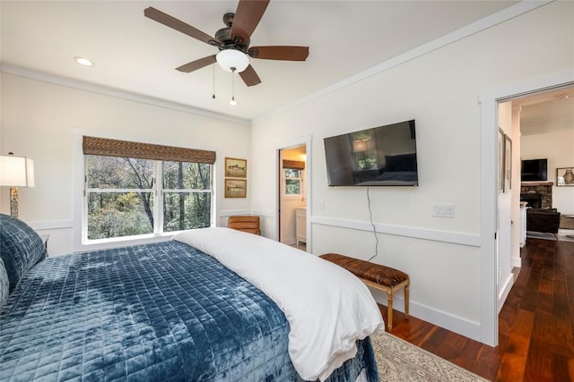 bedroom with crown molding, baseboards, ceiling fan, and wood finished floors