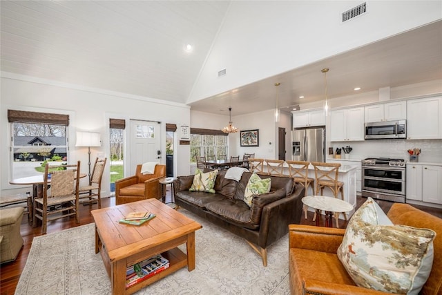 living room with recessed lighting, visible vents, light wood-style flooring, and an inviting chandelier