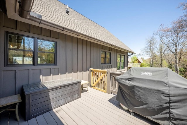 wooden deck featuring a grill