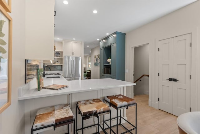 1077 Hicks Rd Unit A, Highlands, NC 28741 - kitchen featuring freestanding refrigerator, open shelves, a peninsula, light countertops, and a sink