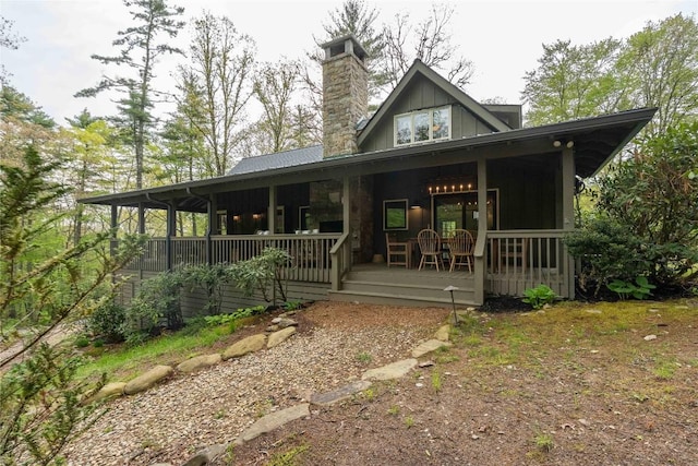 358 Jodytown Rd, Cashiers, NC 28717 - view of front of property with board and batten siding, a porch, and a chimney
