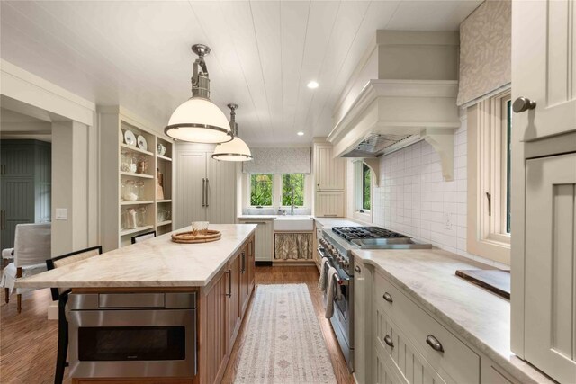 358 Jodytown Rd, Cashiers, NC 28717 - kitchen featuring stainless steel stove, wood finished floors, light stone counters, open shelves, and a center island