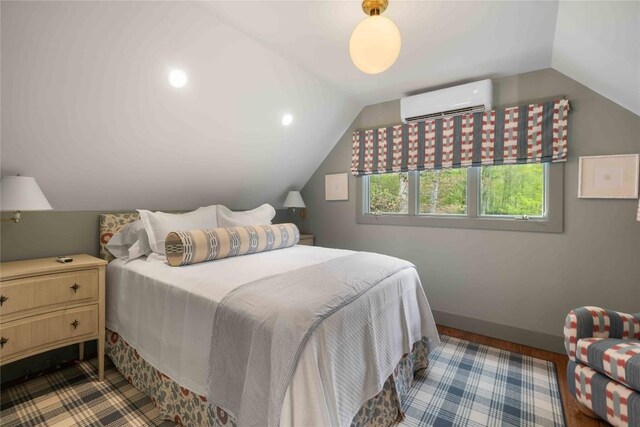 358 Jodytown Rd, Cashiers, NC 28717 - bedroom featuring a wall mounted air conditioner, vaulted ceiling, and baseboards