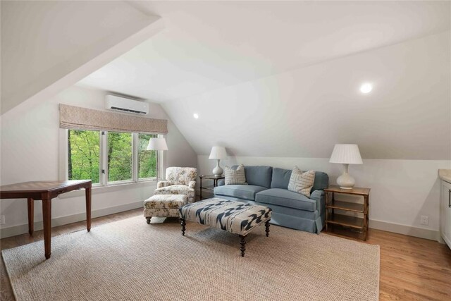 358 Jodytown Rd, Cashiers, NC 28717 - living area with an AC wall unit, lofted ceiling, light wood-type flooring, and baseboards